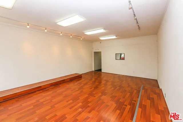 a view of a room with wooden floor