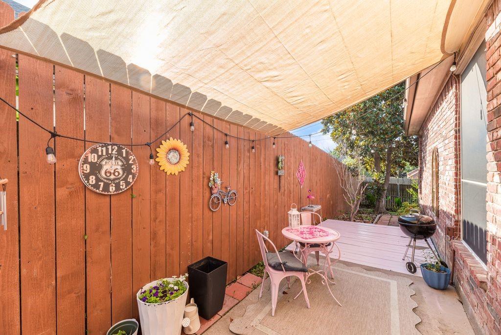 3205 Cape Cod Court Arlington, TX 76017 - Photo 28 of 30 a backyard of a house with table and chairs