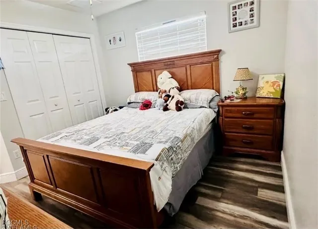 a large bed sitting in a bedroom next to a cabinet