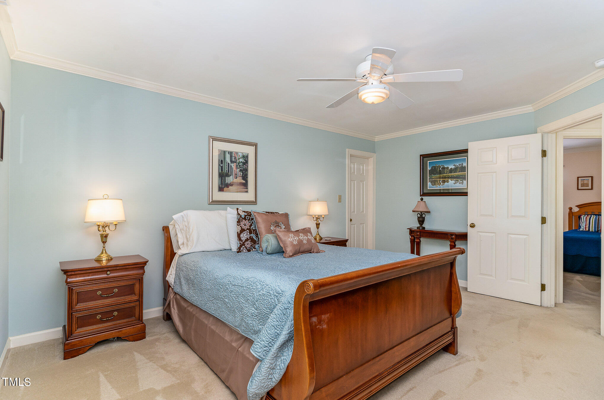 109 Lochfield Drive Cary, NC 27518 - Photo 26 of 43 a bedroom with a bed and a chandelier