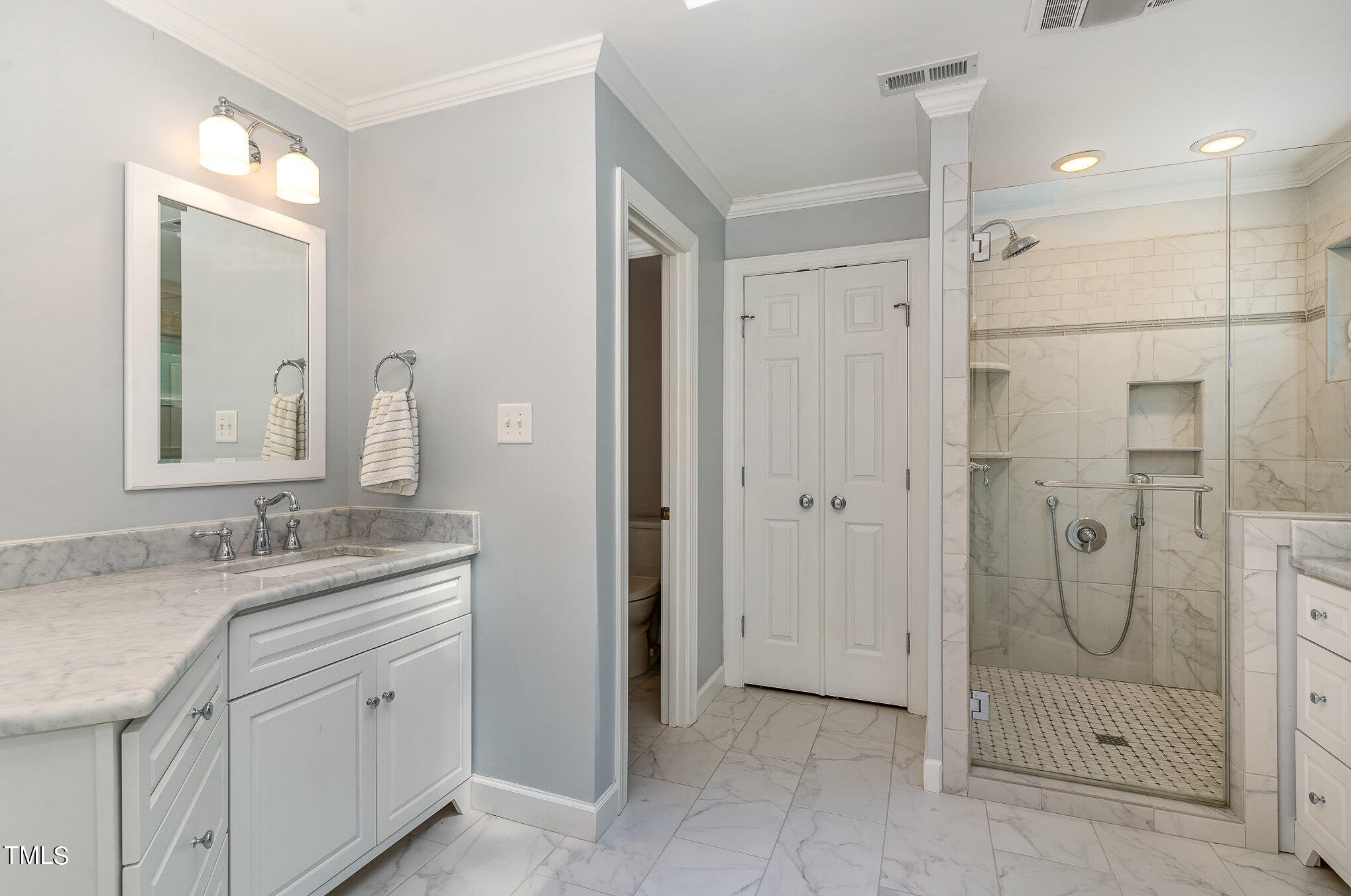 109 Lochfield Drive Cary, NC 27518 - Photo 5 of 43 a bathroom with a granite countertop shower sink and mirror