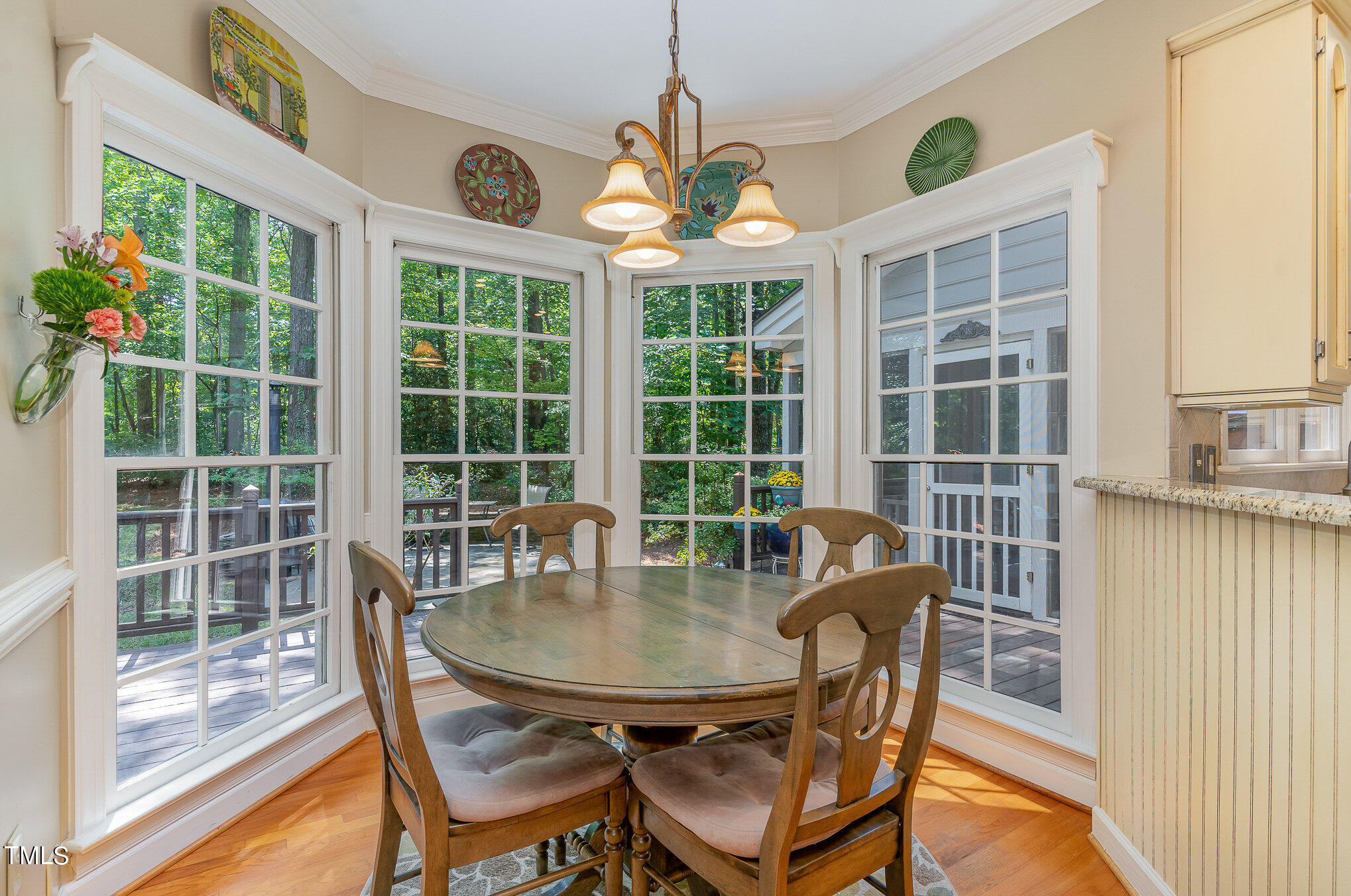 109 Lochfield Drive Cary, NC 27518 - Photo 9 of 43 a dining room with furniture a chandelier and wooden floor