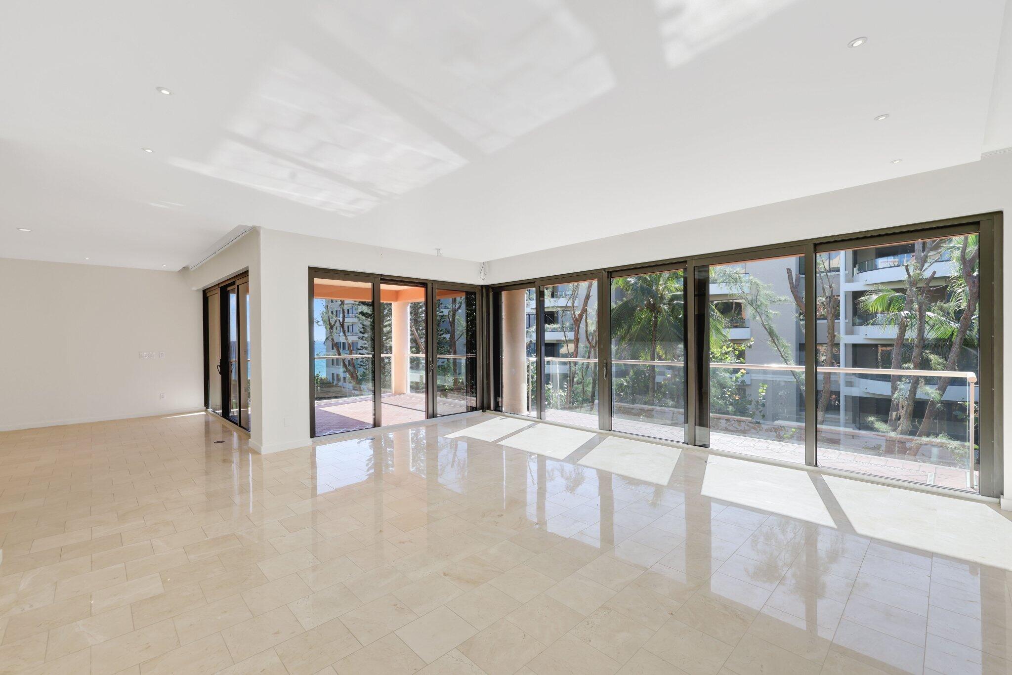 2 North Breakers Row, Unit S32 Palm Beach, FL 33480 - Photo 17 of 77 a view of an empty room with wooden floor and a floor to ceiling window