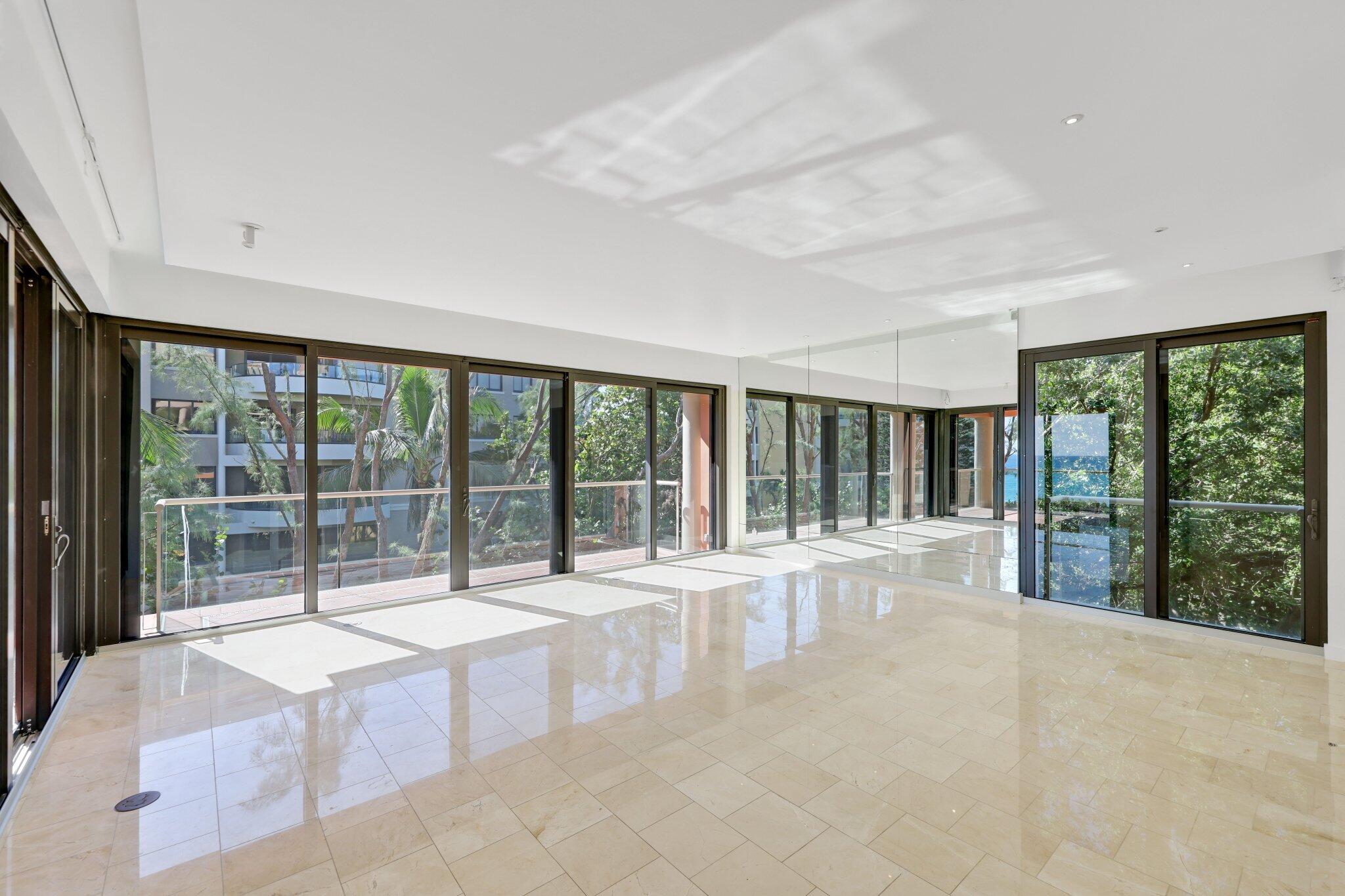 2 North Breakers Row, Unit S32 Palm Beach, FL 33480 - Photo 19 of 77 a view of an empty room with a balcony and floor to ceiling window