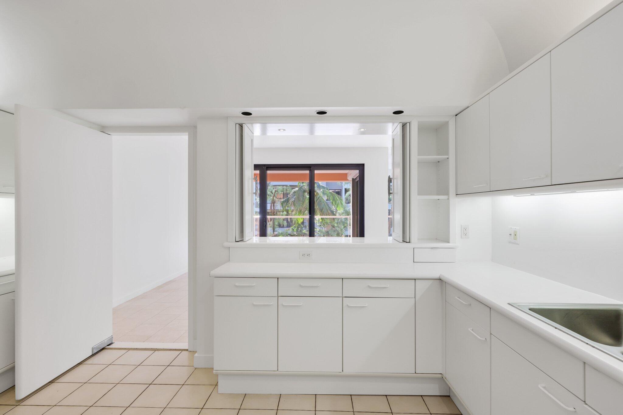 2 North Breakers Row, Unit S32 Palm Beach, FL 33480 - Photo 29 of 77 a kitchen with white cabinets and a window