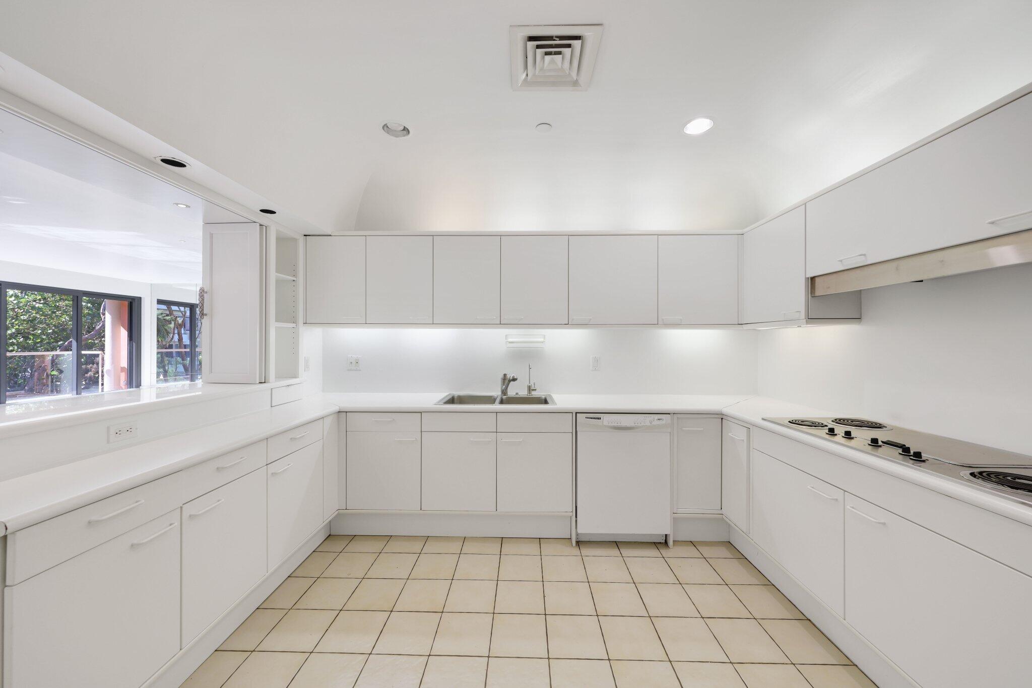 2 North Breakers Row, Unit S32 Palm Beach, FL 33480 - Photo 31 of 77 a kitchen with a sink a stove and cabinets