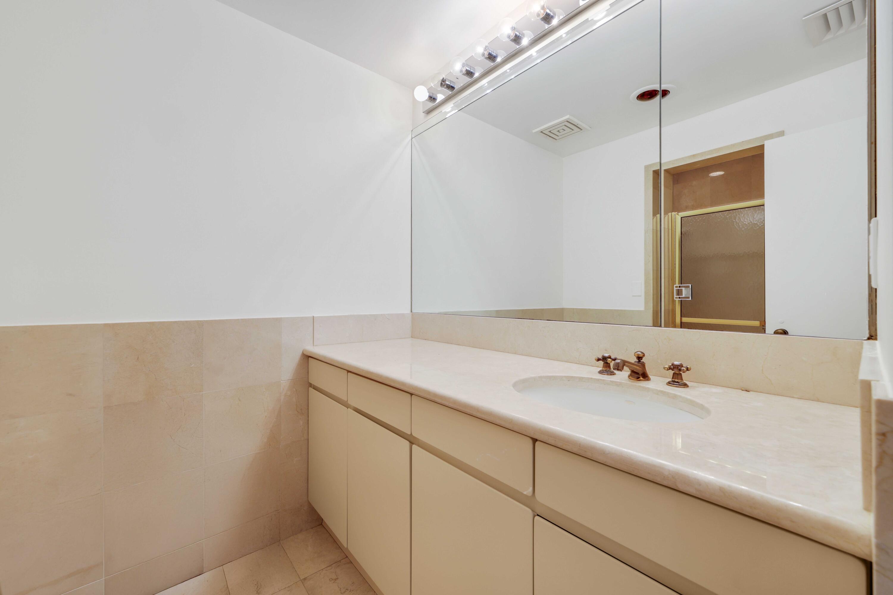 2 North Breakers Row, Unit S32 Palm Beach, FL 33480 - Photo 45 of 77 a bathroom with a sink and a mirror