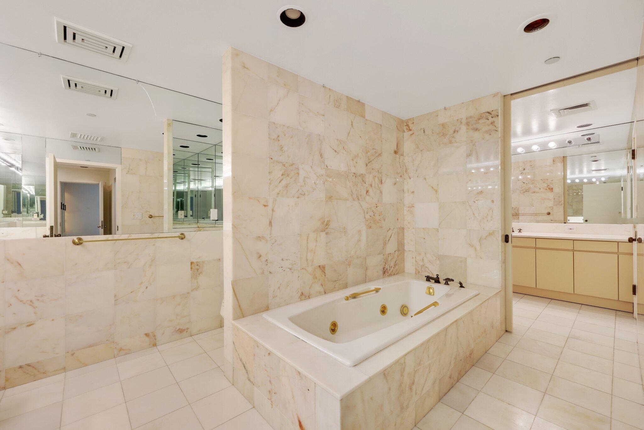 2 North Breakers Row, Unit S32 Palm Beach, FL 33480 - Photo 51 of 77 a bathroom with a bathtub a sink and a mirror