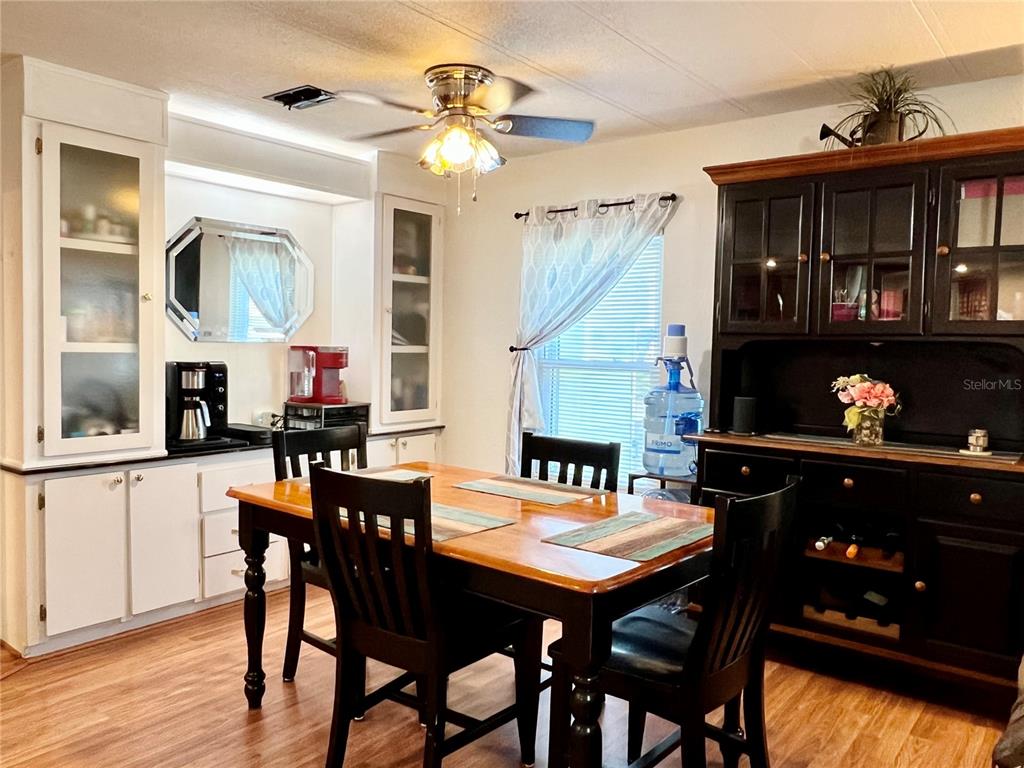2 South Bobwhite Road Wildwood, FL 34785 - Photo 14 of 57 a view of a dining room with furniture and wooden floor