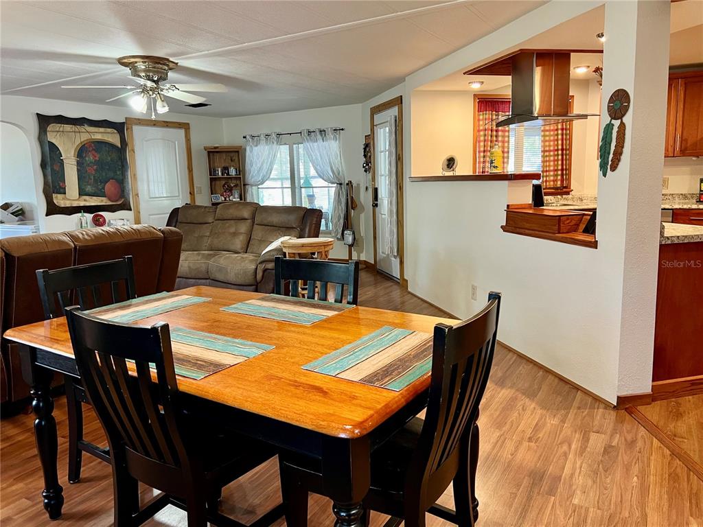 2 South Bobwhite Road Wildwood, FL 34785 - Photo 18 of 57 a view of a dining room with furniture and a chandelier