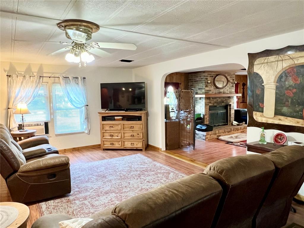2 South Bobwhite Road Wildwood, FL 34785 - Photo 3 of 57 a living room with furniture and a flat screen tv
