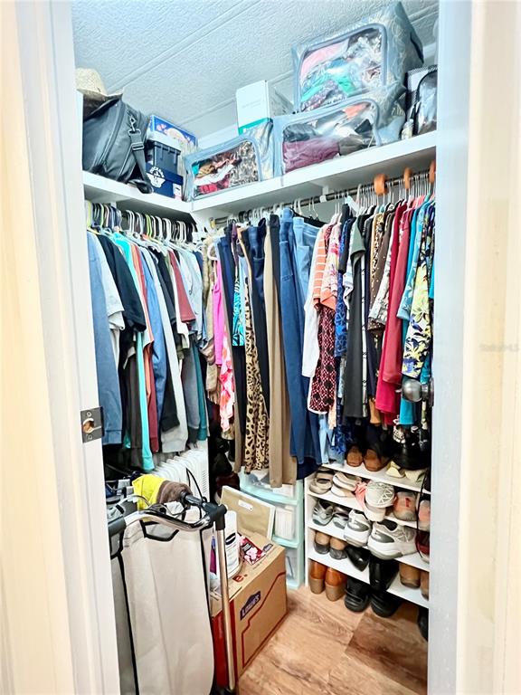 2 South Bobwhite Road Wildwood, FL 34785 - Photo 35 of 57 a view of walk in closet with clothes and shoes