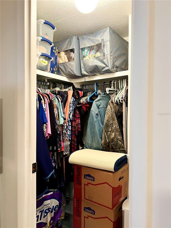 2 South Bobwhite Road Wildwood, FL 34785 - Photo 38 of 57 a view of walk in closet with clothes and shoes