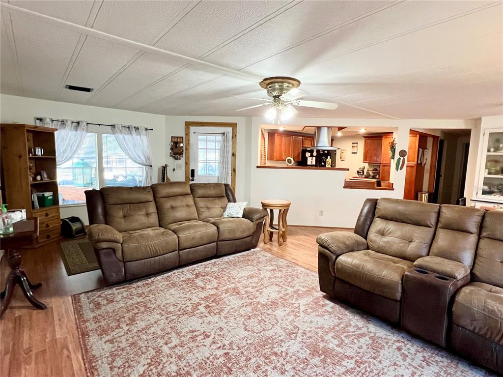 2 South Bobwhite Road Wildwood, FL 34785 - Photo 7 of 57 a living room with furniture and a large window