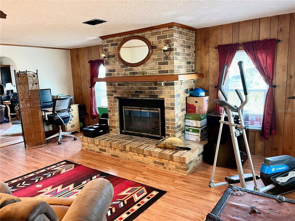 2 South Bobwhite Road Wildwood, FL 34785 - Photo 10 of 57 a living room with furniture and a fireplace