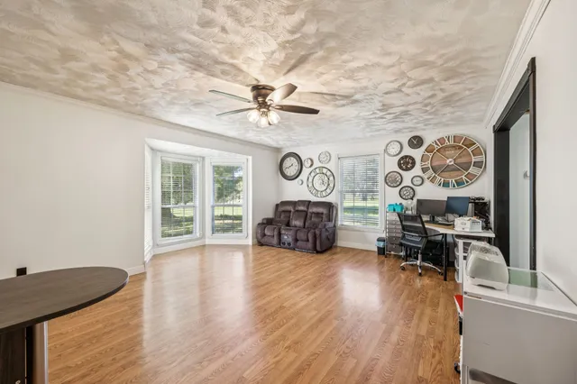 a view of a house with wooden deck and sitting area