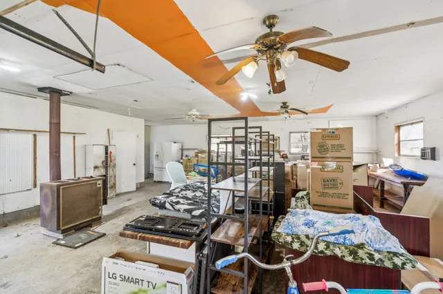 a living room with lots of furniture and kitchen view