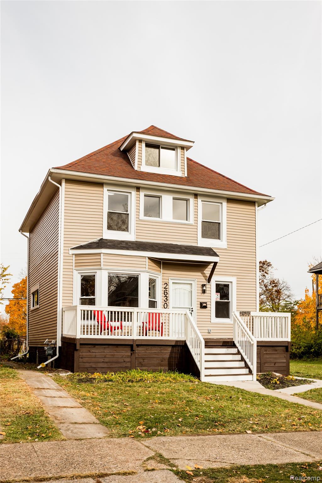 2630 Harding Street Detroit, MI 48214 - Photo 2 of 30 Cream-colored siding exterior featuring a prominent dormer, bay window, and a front porch with white railings