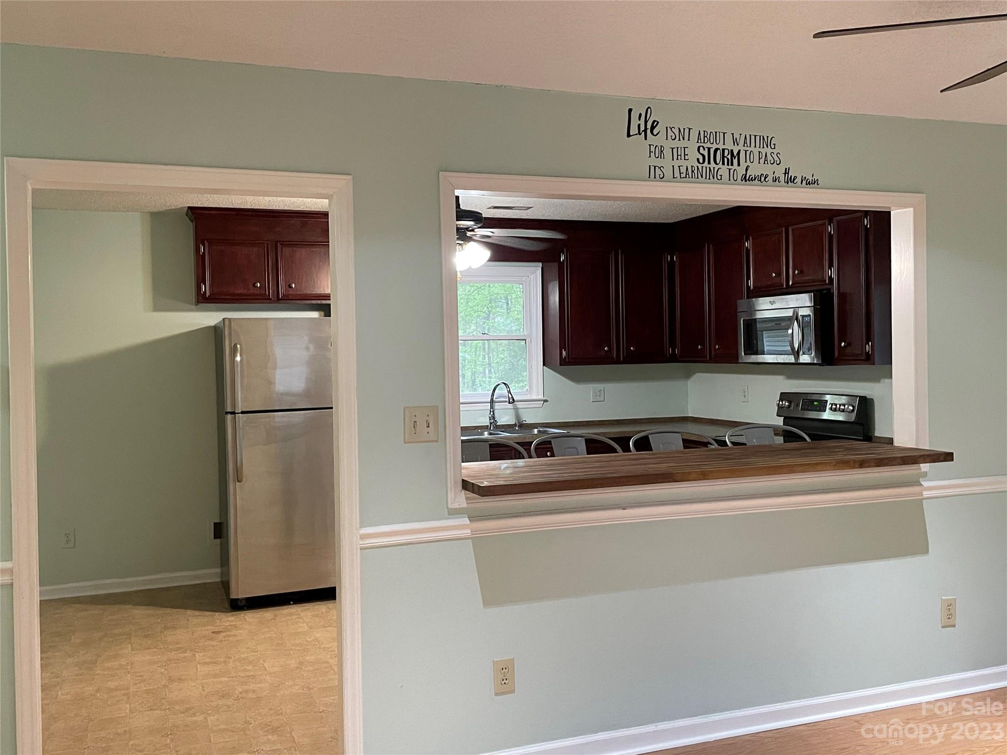 3885 Taxahaw Road Lancaster, SC 29720 - Photo 3 of 18 a kitchen with stainless steel appliances a refrigerator and a stove top oven