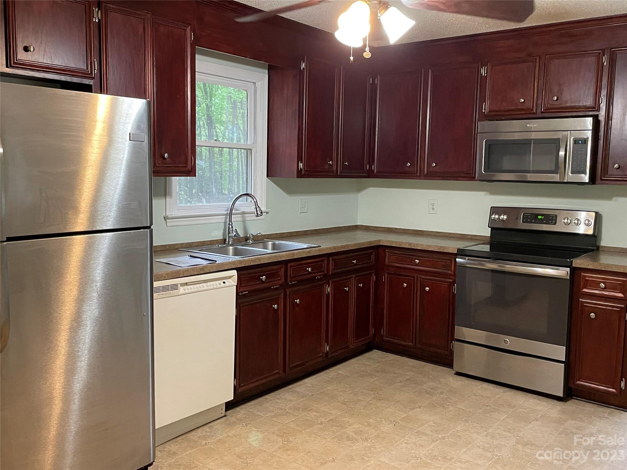 3885 Taxahaw Road Lancaster, SC 29720 - Photo 5 of 18 a kitchen with stainless steel appliances granite countertop a refrigerator a stove a sink and dishwasher