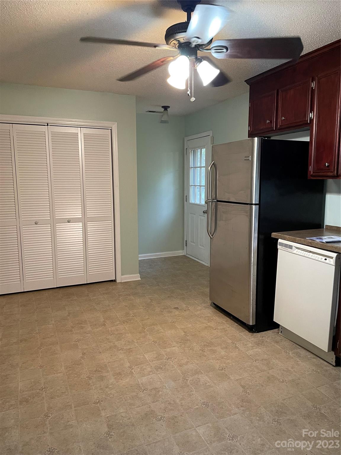 3885 Taxahaw Road Lancaster, SC 29720 - Photo 6 of 18 a view of a kitchen with a refrigerator a ceiling fan and a refrigerator