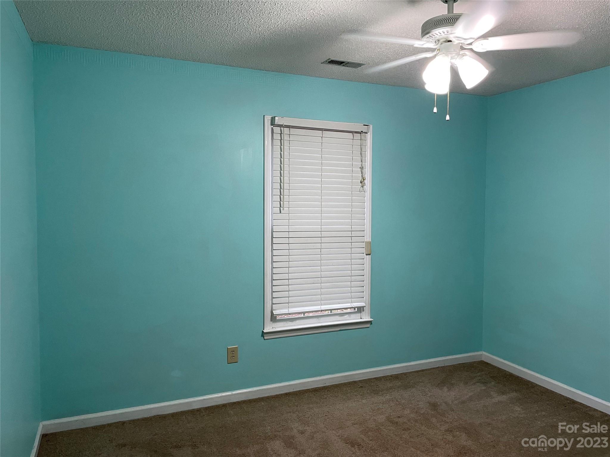 3885 Taxahaw Road Lancaster, SC 29720 - Photo 7 of 18 an empty room with a window and a fan
