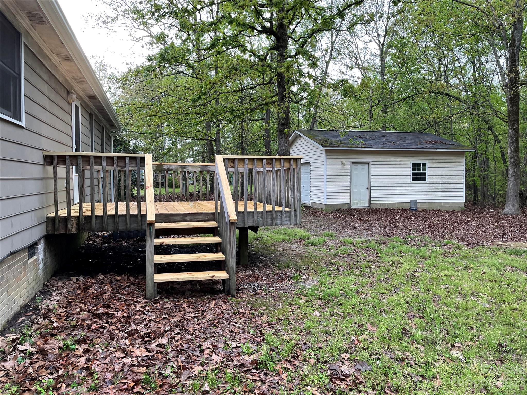 3885 Taxahaw Road Lancaster, SC 29720 - Photo 10 of 18 a backyard of a house with wooden floor and fence