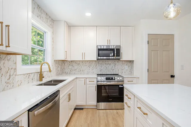 a kitchen with a sink stove and microwave