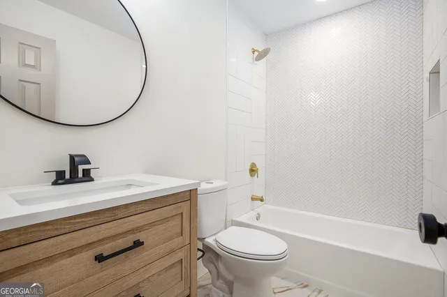 a bathroom with a sink a toilet and a mirror