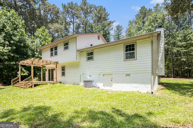 a front view of a house with a yard and trees