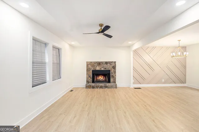a view of a livingroom with a fireplace and window