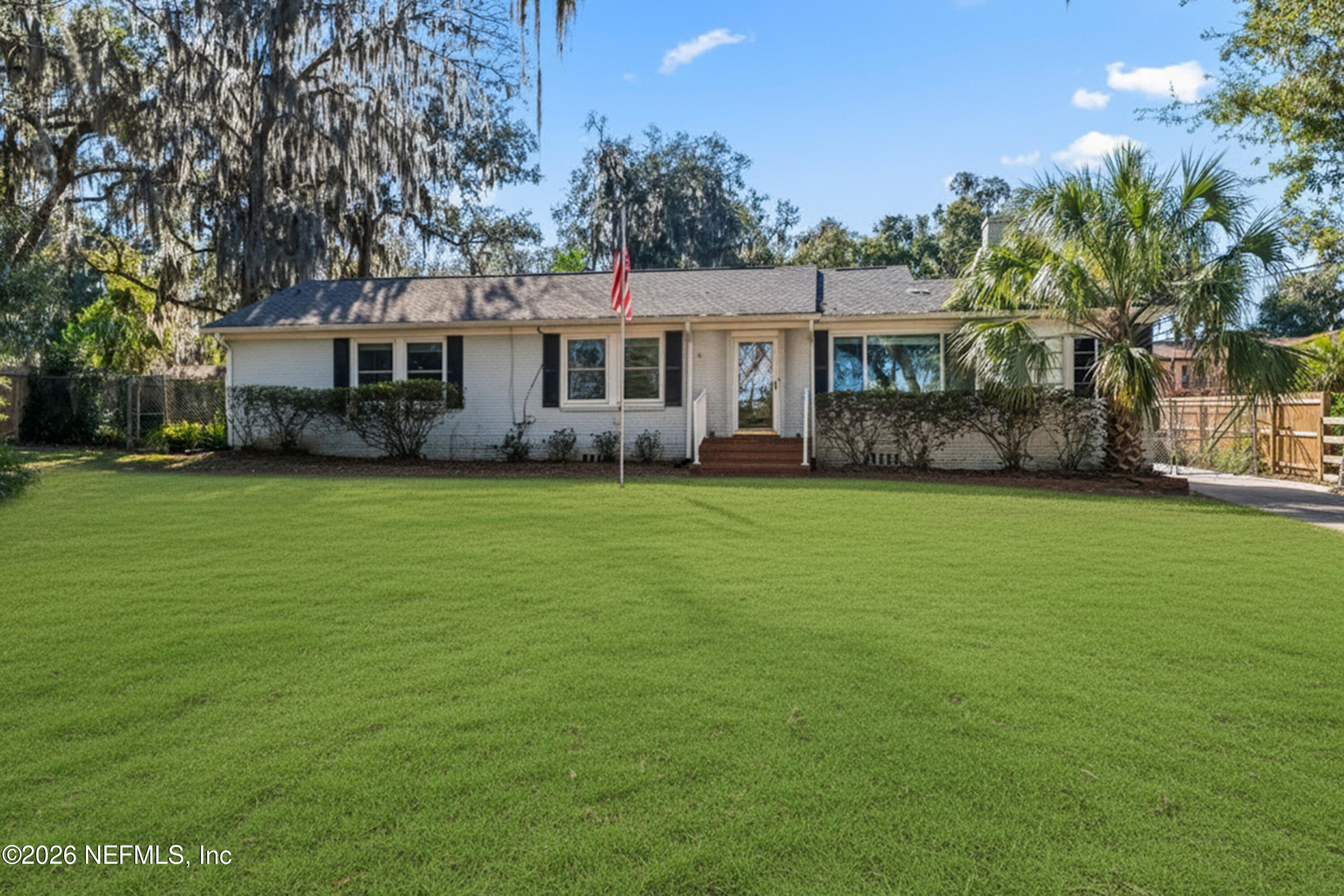 10612 Fort Caroline Road Jacksonville, FL 32225 - Photo 1 of 51 a view of a house next to a big yard and large trees
