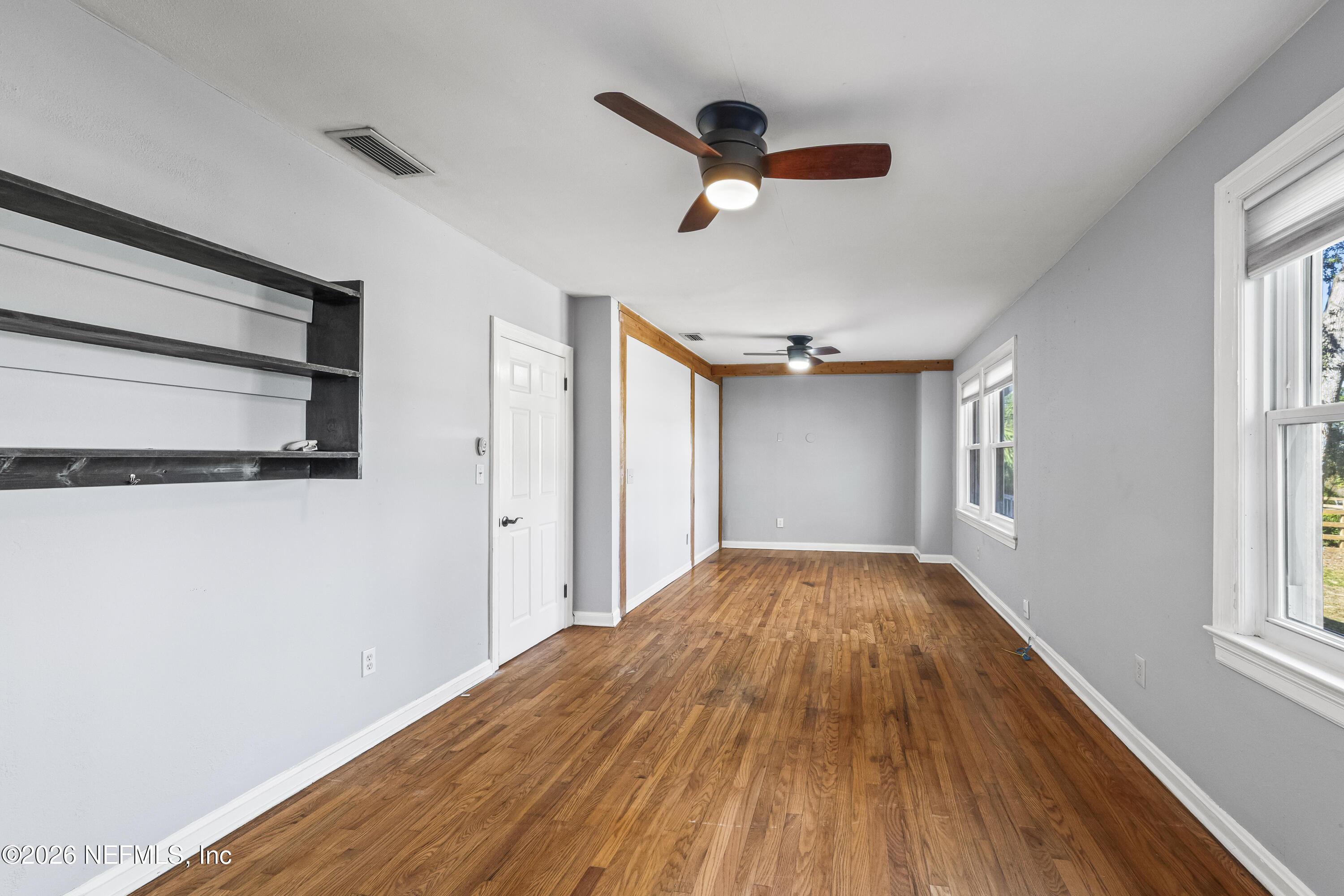 10612 Fort Caroline Road Jacksonville, FL 32225 - Photo 11 of 51 a view of empty room with wooden floor and fan