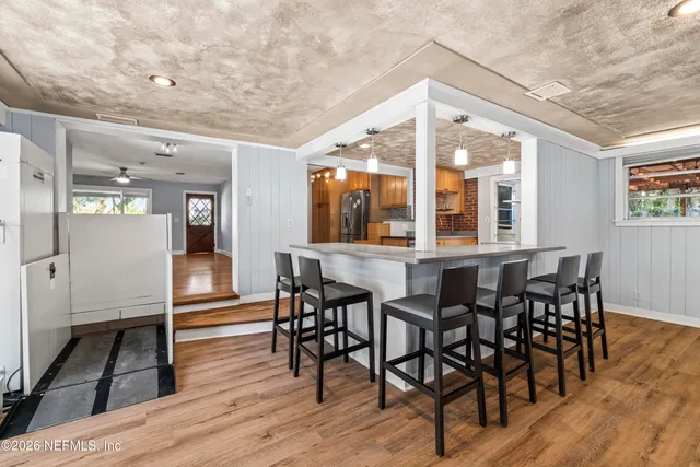 a view of a dining room with furniture wooden floor and chandelier