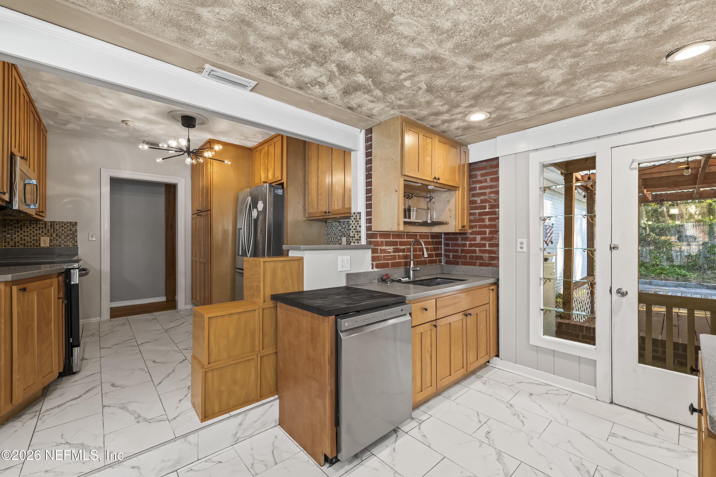 10612 Fort Caroline Road Jacksonville, FL 32225 - Photo 20 of 51 a kitchen with stainless steel appliances granite countertop a sink and cabinets