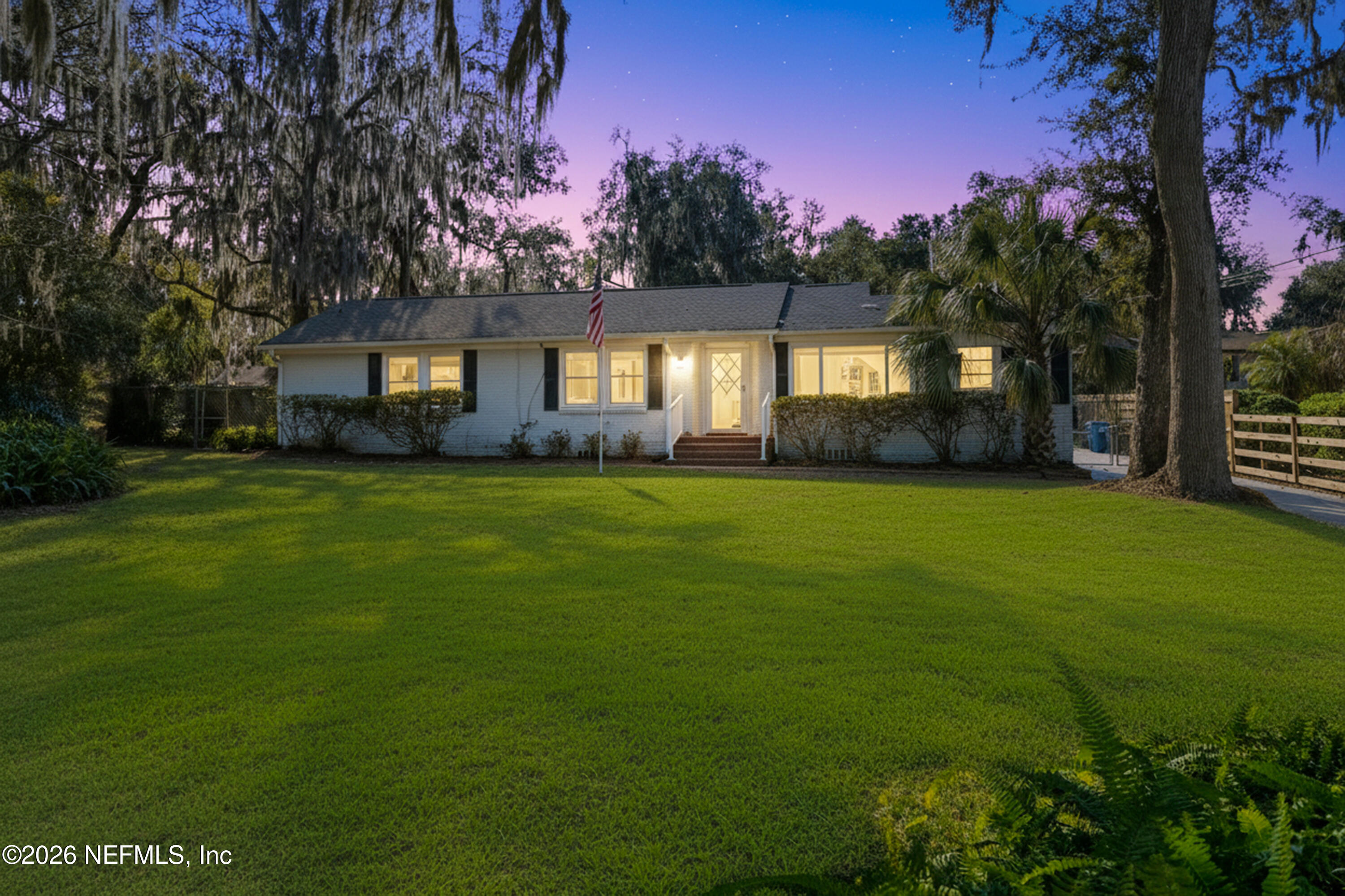 10612 Fort Caroline Road Jacksonville, FL 32225 - Photo 2 of 51 a yellow house with a yard
