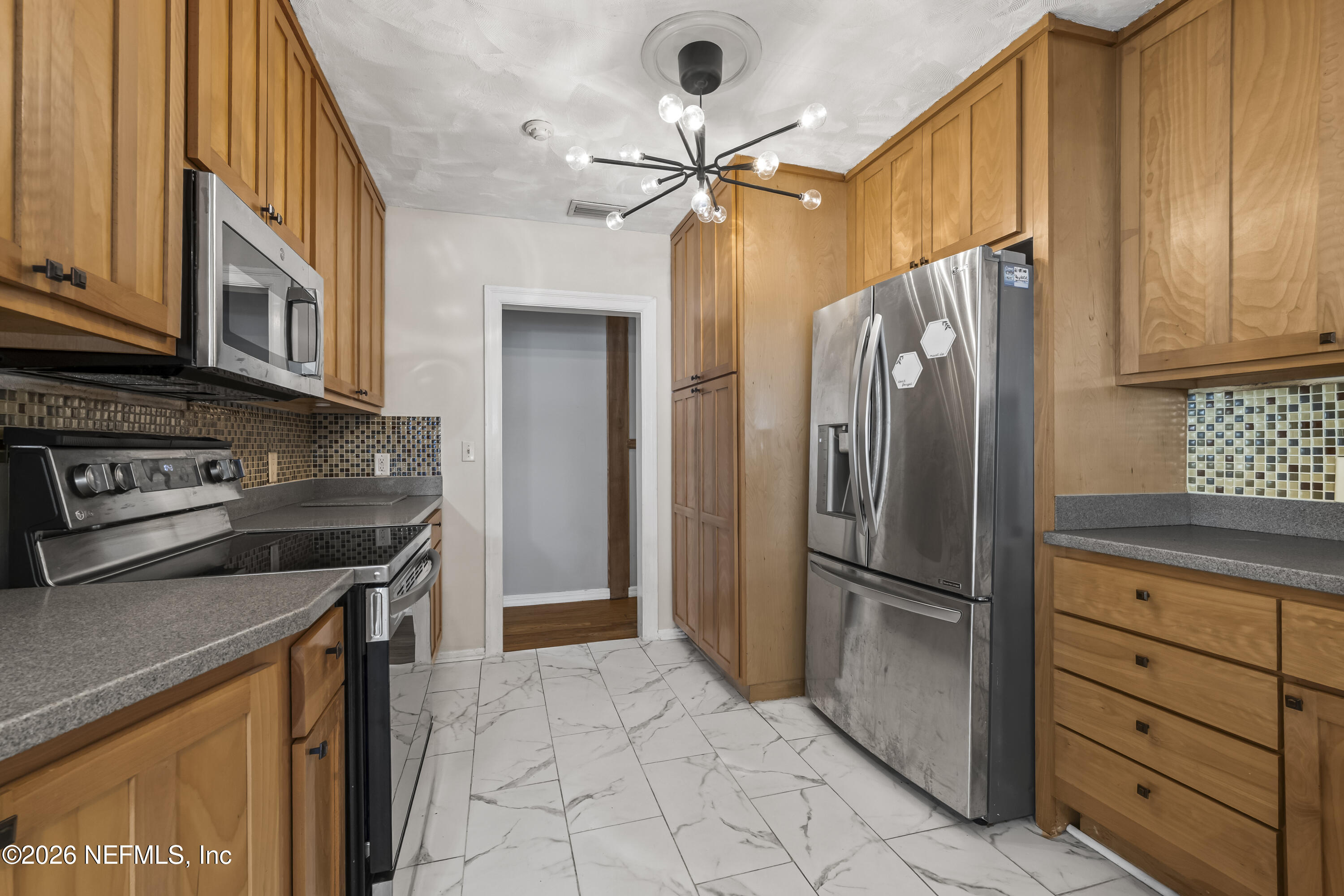 10612 Fort Caroline Road Jacksonville, FL 32225 - Photo 21 of 51 a kitchen with stainless steel appliances granite countertop a refrigerator a stove and a sink
