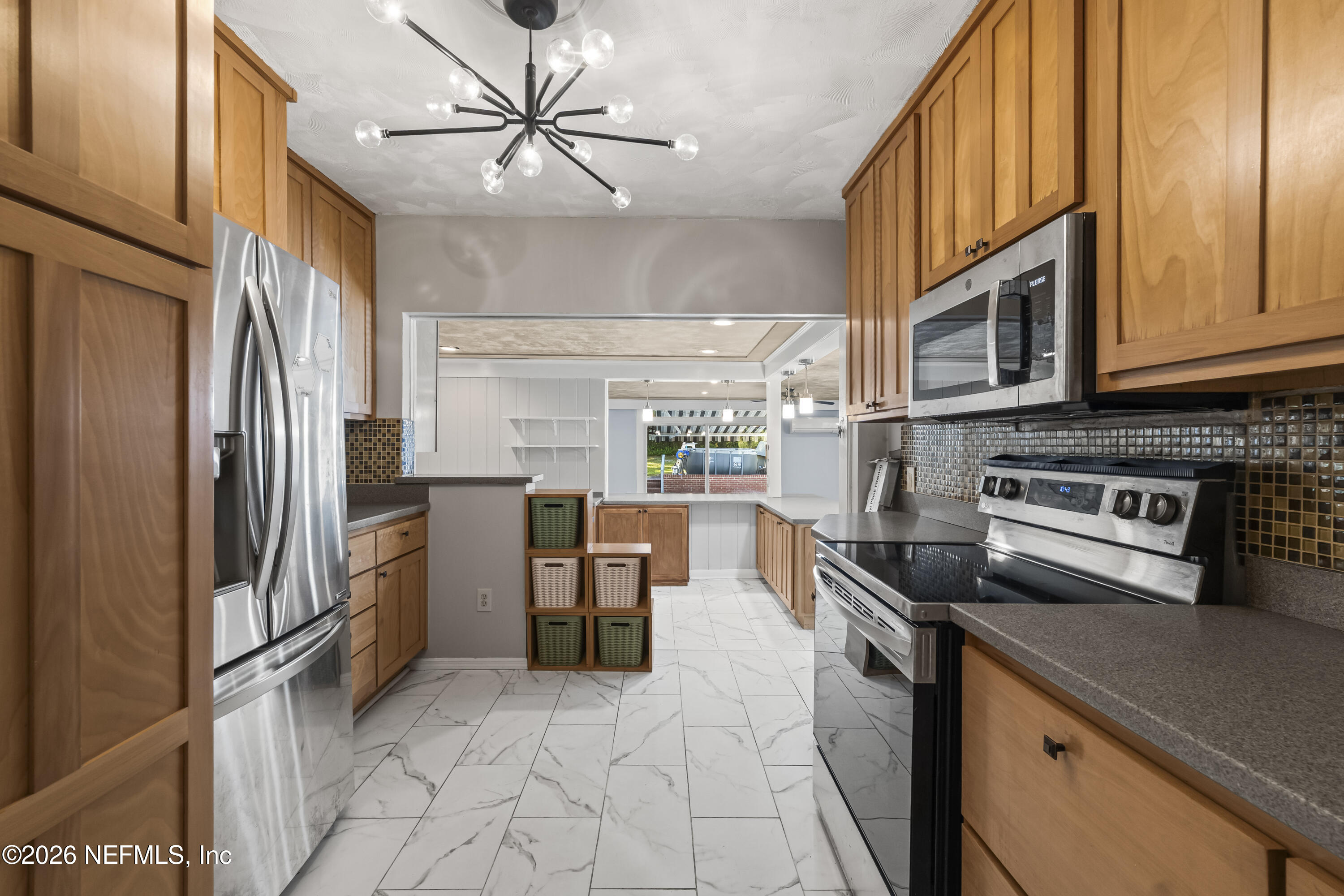 10612 Fort Caroline Road Jacksonville, FL 32225 - Photo 22 of 51 a kitchen with stainless steel appliances granite countertop a refrigerator a stove and a sink with cabinets