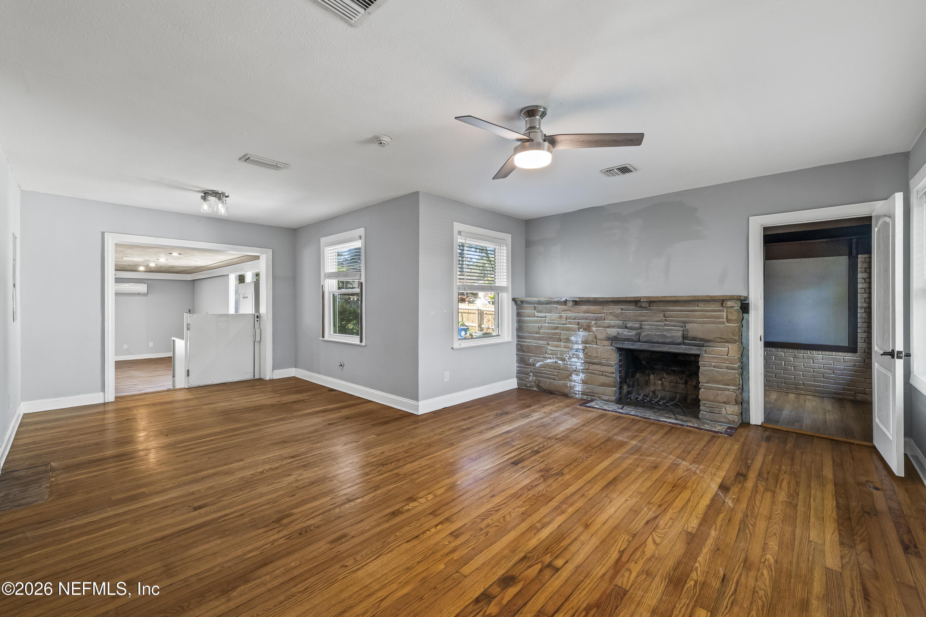 10612 Fort Caroline Road Jacksonville, FL 32225 - Photo 3 of 51 a view of an empty room with wooden floor fireplace and a window