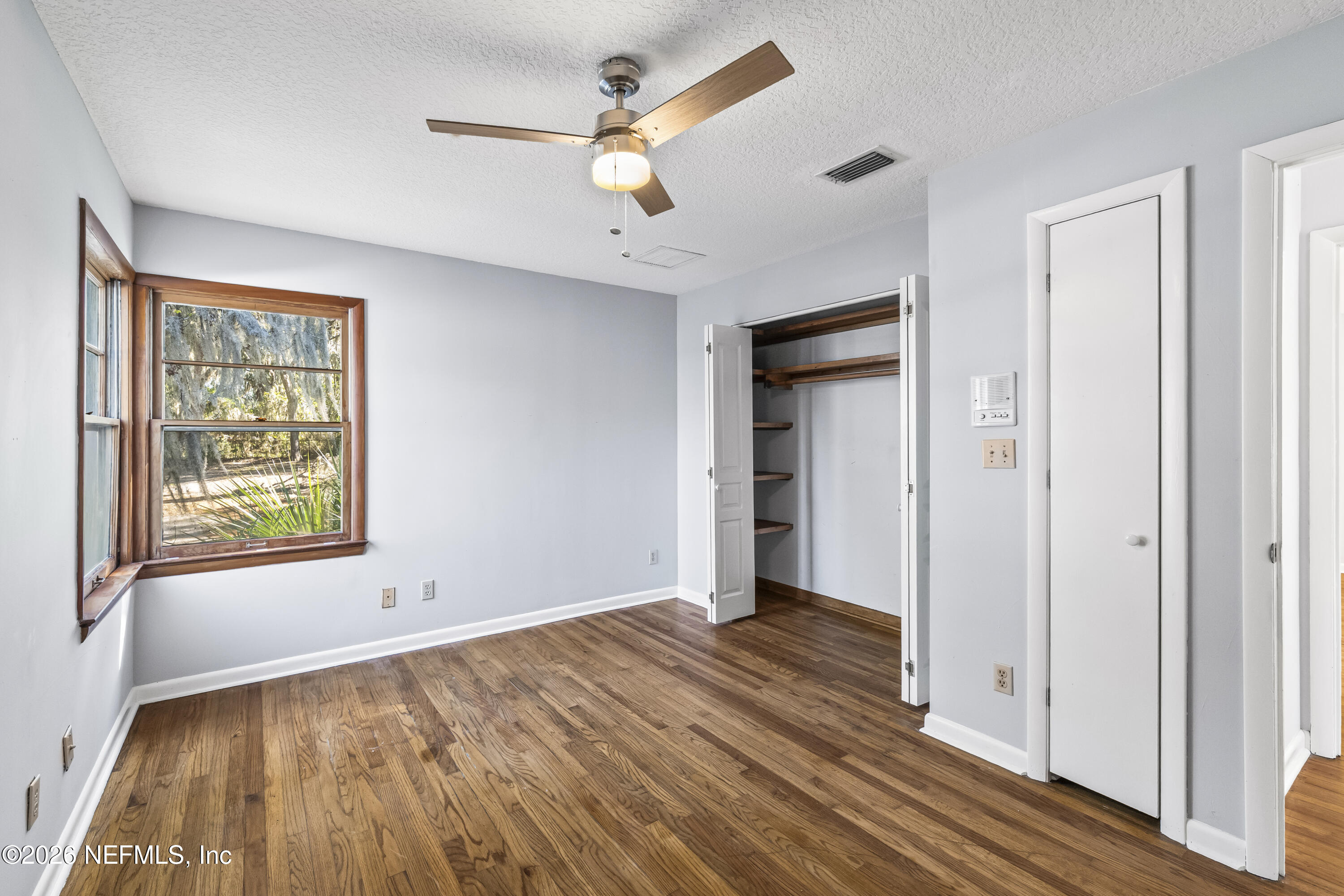 10612 Fort Caroline Road Jacksonville, FL 32225 - Photo 35 of 51 wooden floor in an empty room with a window