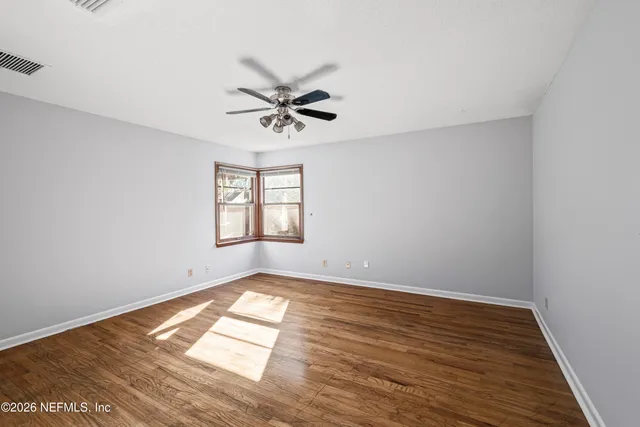 a view of a kitchen with wooden floor a ceiling fan and wooden floor