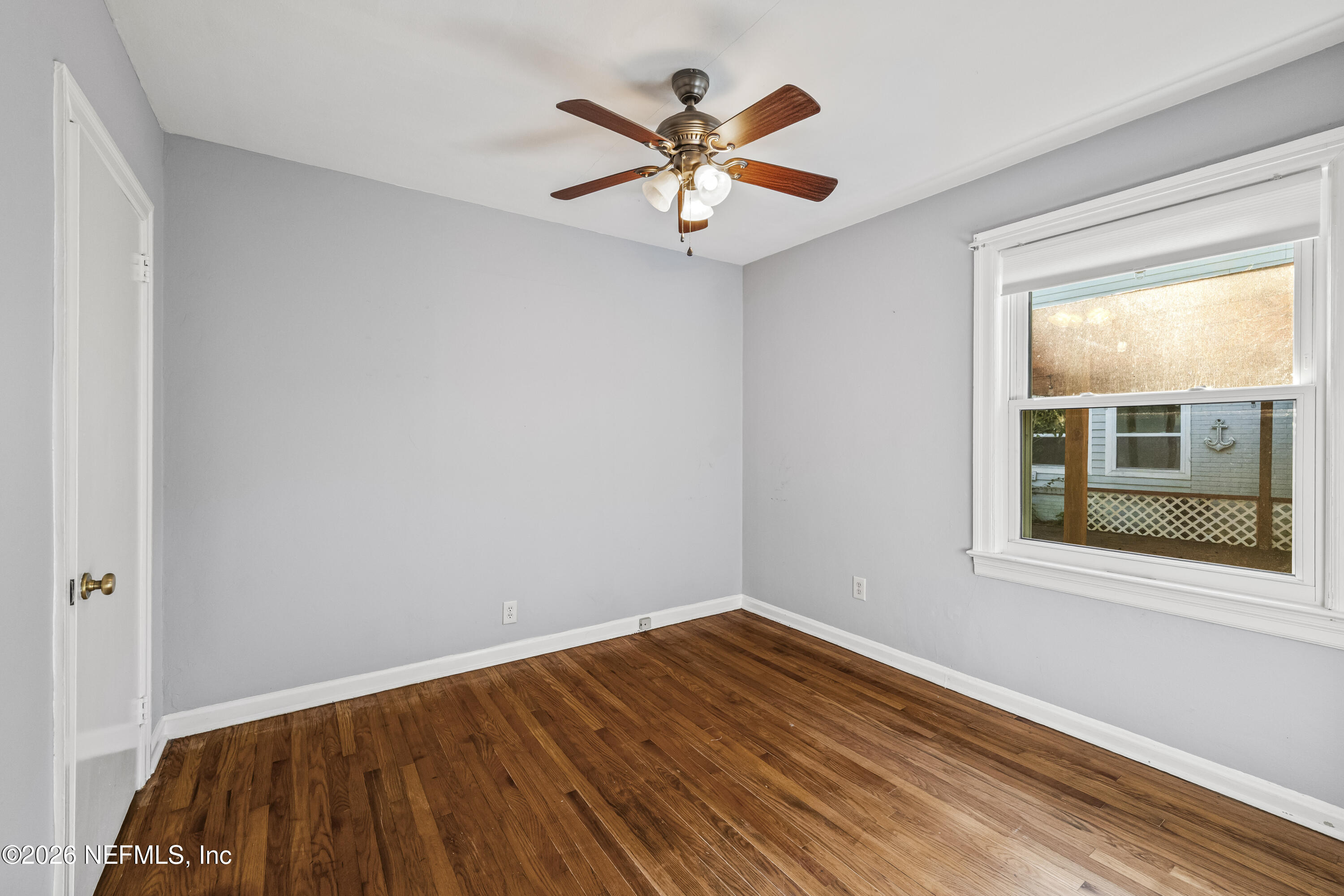 10612 Fort Caroline Road Jacksonville, FL 32225 - Photo 8 of 51 a view of empty room with wooden floor and ceiling fan