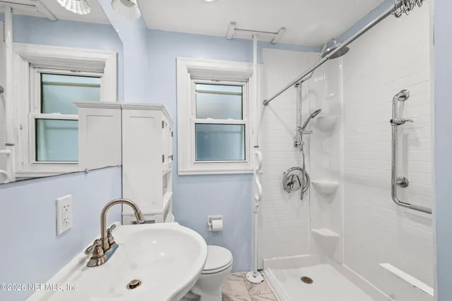 a bathroom with a sink toilet and shower