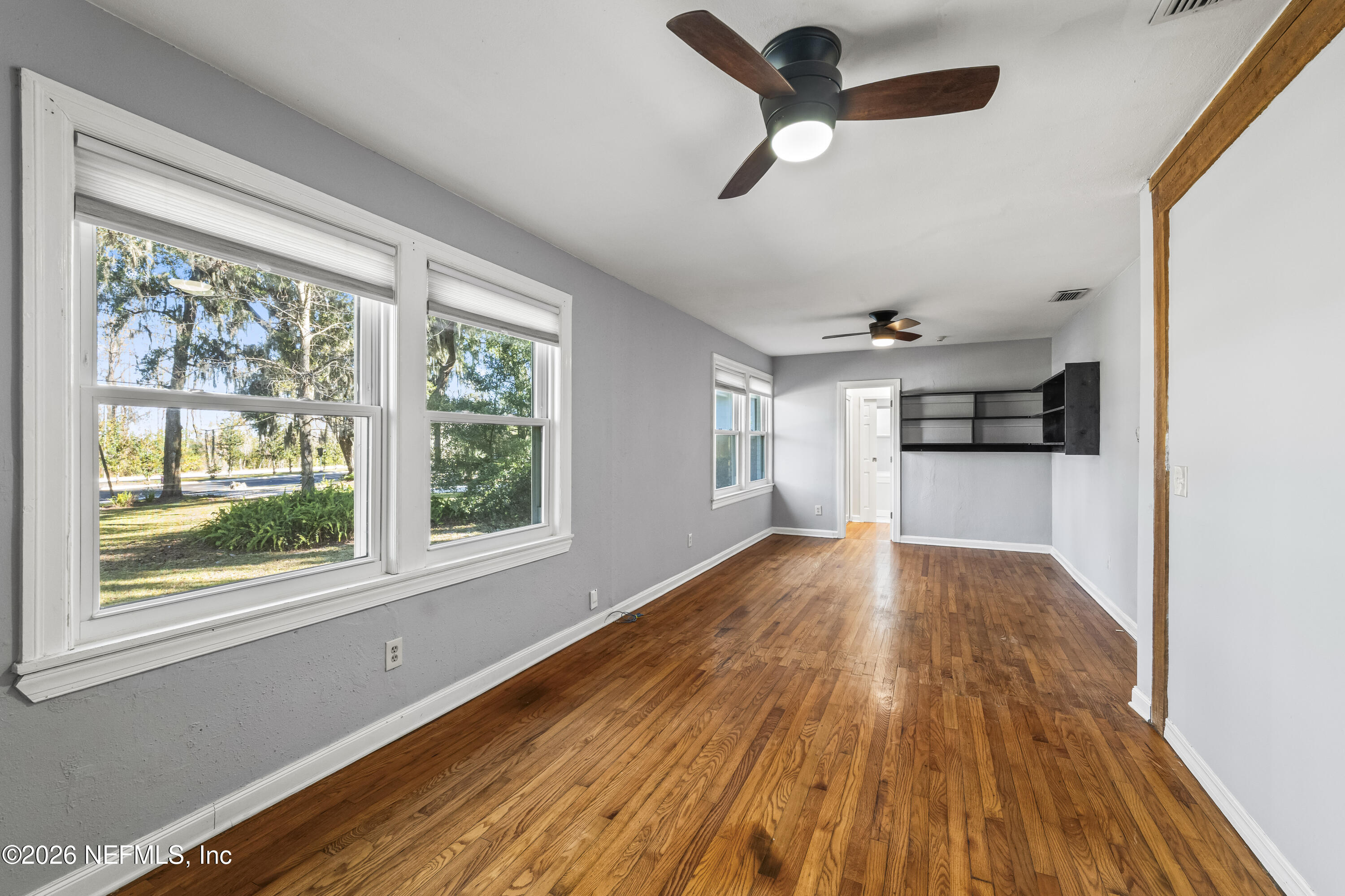 10612 Fort Caroline Road Jacksonville, FL 32225 - Photo 10 of 51 a view of empty room with wooden floor and window