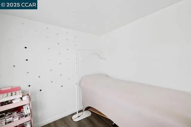 a bedroom with a bed and a flat tv screen on a dresser