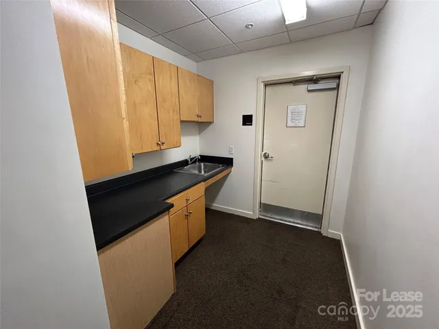 a kitchen with a stove a sink and a refrigerator