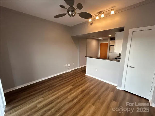 wooden floor in an empty room with a mirror