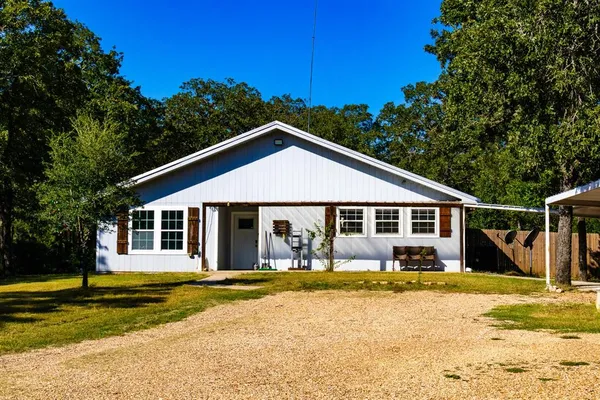 a front view of a house with swimming pool and porch