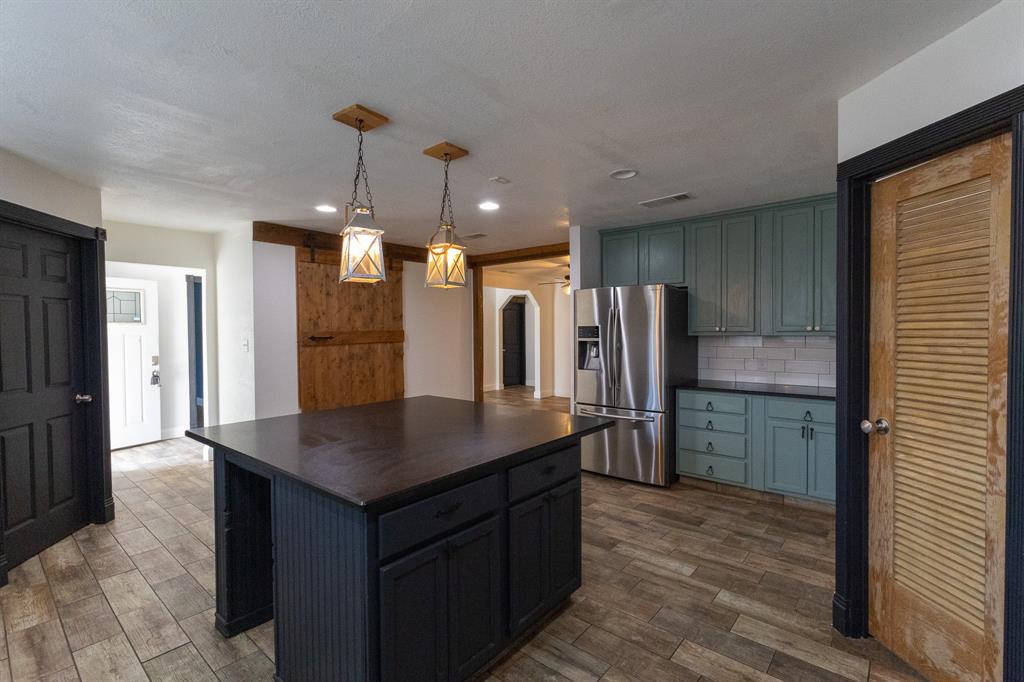 536 Cavin Lane Axtell, TX 76624 - Photo 16 of 40 a kitchen with stainless steel appliances granite countertop a refrigerator a sink and a stove