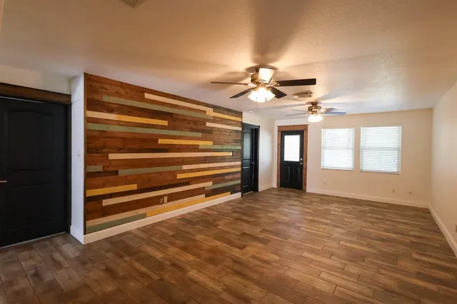 a view of a room with wooden floor and a window